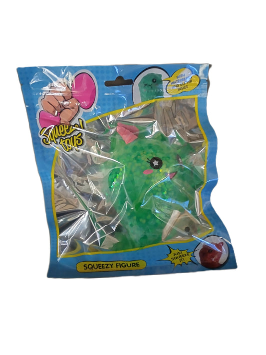 Green squishy narwhal figure in a blue packaging with 'Squeezes' branding.