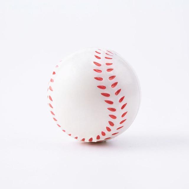 White baseball with red stitching on a white background